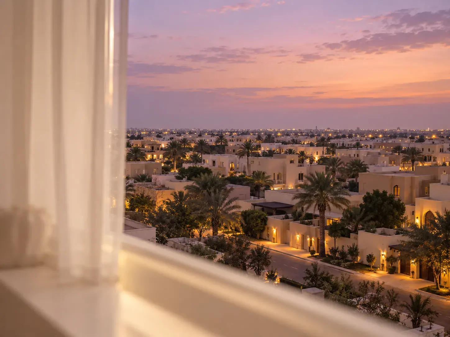 A Gulf neighbourhood at dusk, seen from a clinic window